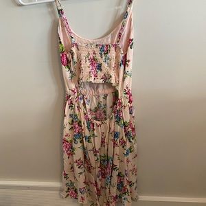 Fitted pink floral open back dress. Fits small women or child. Barley worn.